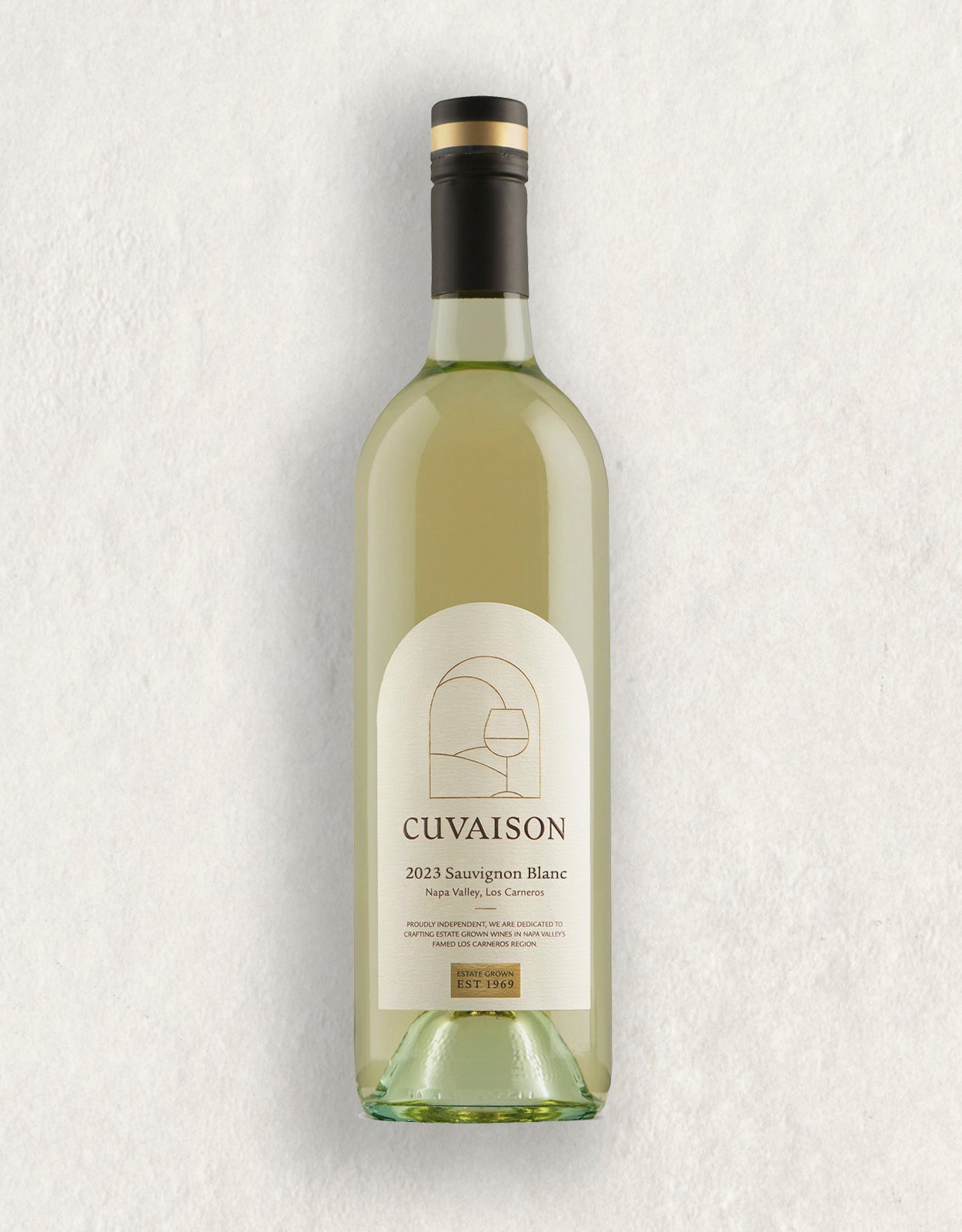 A bottle of 2023 Cuvaison Estate Sauvignon Blanc with light gold wine, a white label featuring minimalist artwork and gold text, stands upright on a neutral, lightly textured surface.