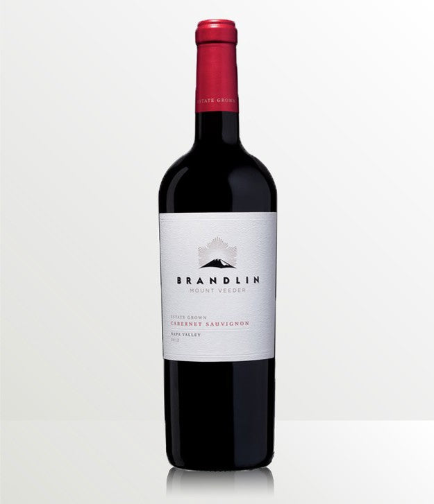 A 1.5L bottle of 2012 Brandlin Estate Cabernet Sauvignon stands on a reflective white surface, featuring a white label and red foil capsule, set against a light background.