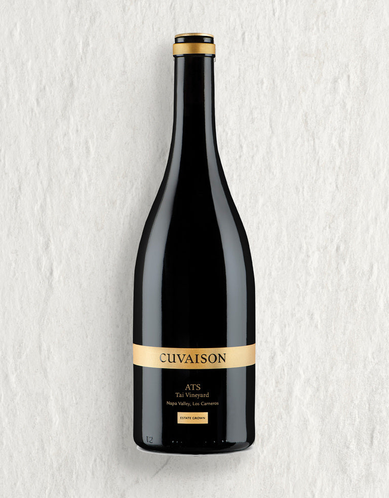 A bottle of 2022 Cuvaison Chardonnay, ATS stands upright against a light textured background, featuring a gold label with the brand name and wine details in black text.