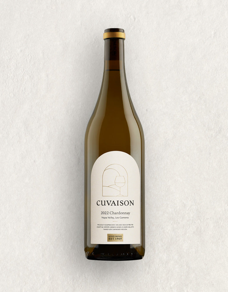 A bottle of 2022 Cuvaison Estate Chardonnay with a minimalist cream label featuring geometric line art, set against a light, textured background.
