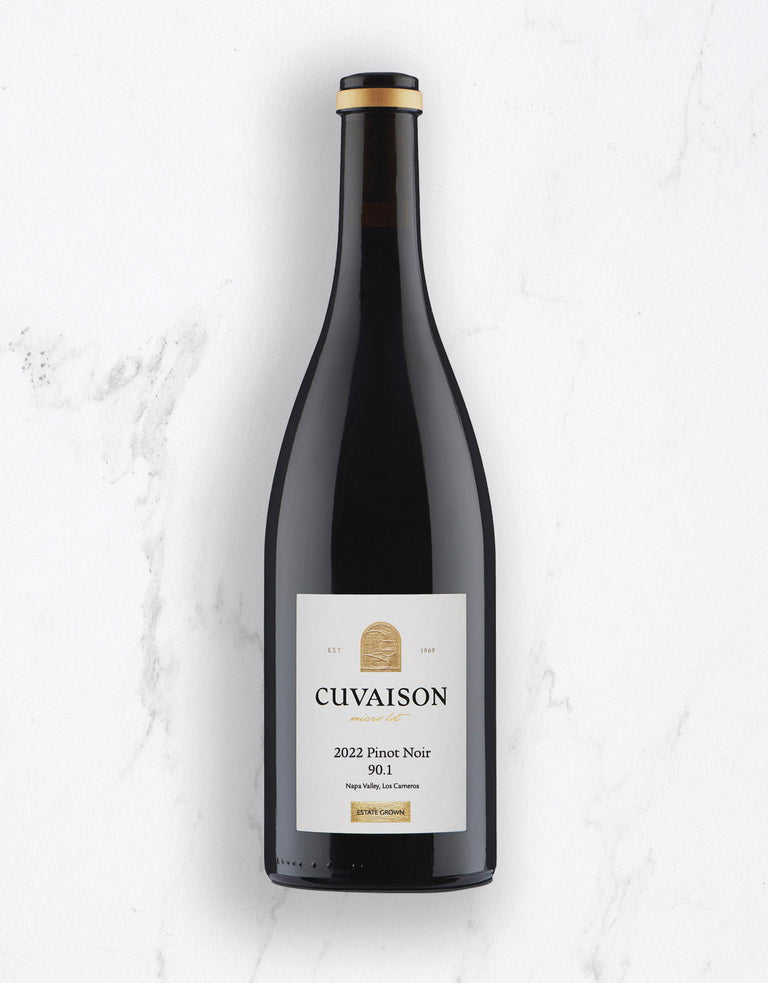 A bottle of 2022 Cuvaison Pinot Noir, 90.1 stands upright on a white marble surface. The label shows the winery name, vintage year, varietal, and 90.1 with smaller text below.